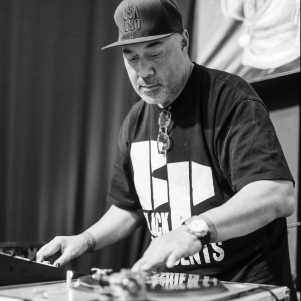 Action shot DJ Black President Behind the DJ Decks