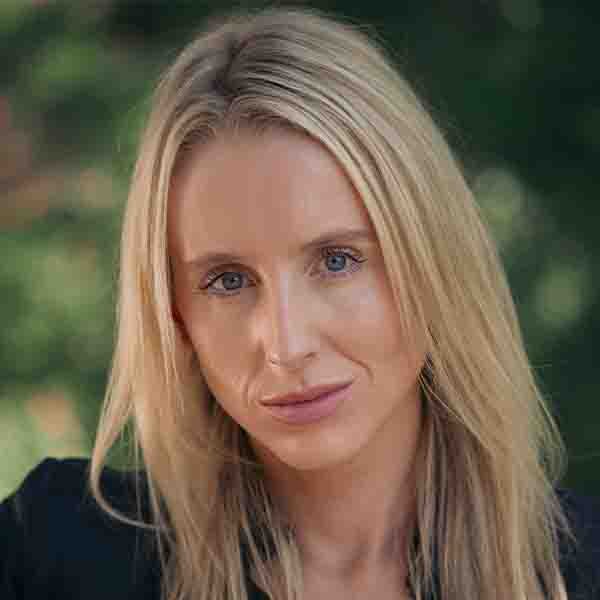 Close-up portrait of journalist, broadcaster, and 2SER 'Fourth Estate' host Tina Quinn with blonde hair against a softly blurred green background.