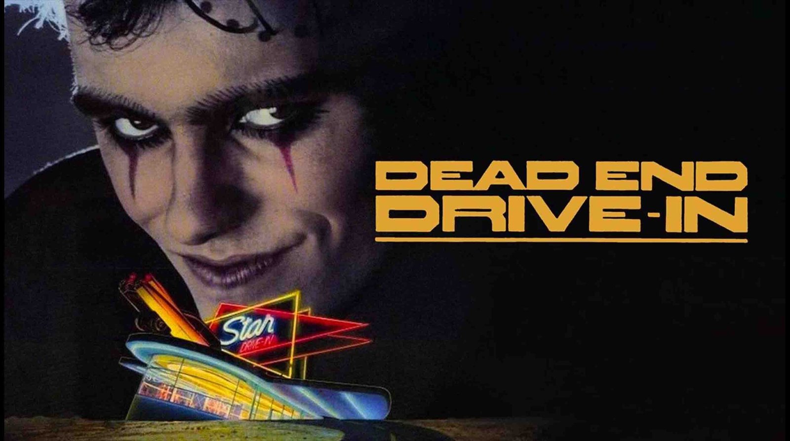Promotional poster for the cult Australian dystopian classic film 'Dead End Drive-In', showing a close-up of a character with dark face paint alongside the stylized movie title and neon drive-in theater graphic.