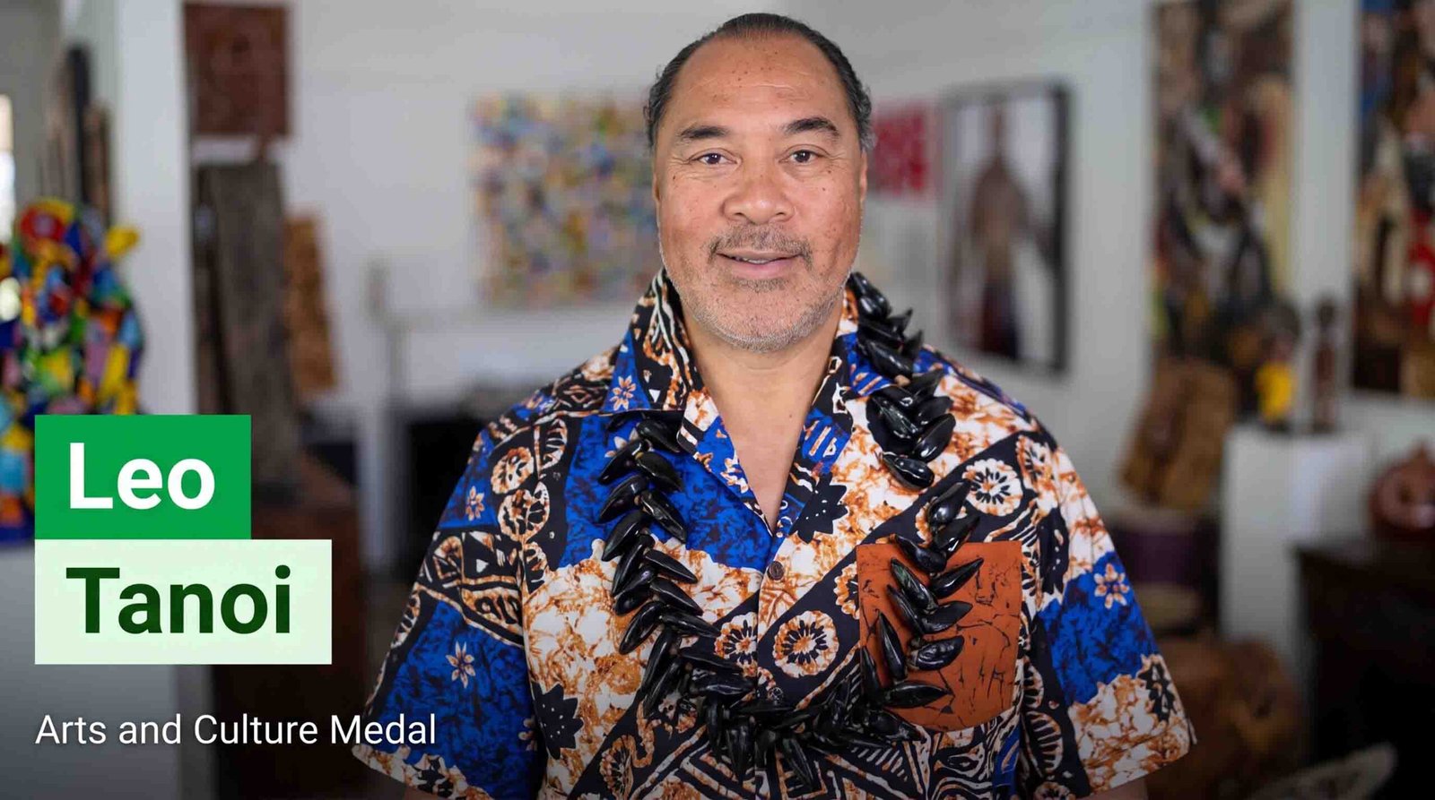 Portrait of Leo Tanoi wearing a traditional Pacific island patterned shirt and black shell necklace, with text overlay reading "Leo Tanoi - Arts and Culture Medal".