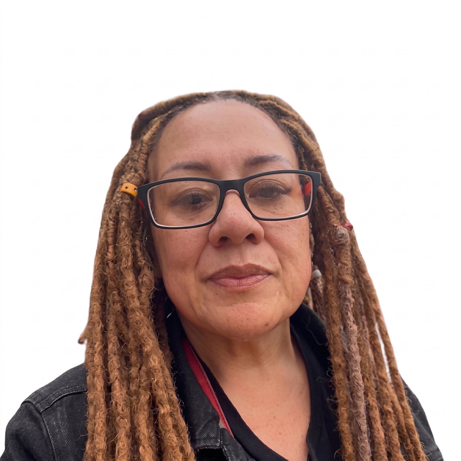 Portrait of Noelani Osueke, Board Member of Multicultural Voices Australia, wearing glasses and dreadlocks against a plain white background.